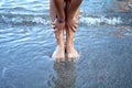 Beautiful woman hands and feet on beach Royalty Free Stock Photo