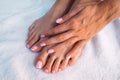 Beautiful woman hands and feet with french manicure and pedicure on a white background Royalty Free Stock Photo