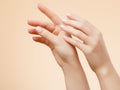 Beautiful Woman Hands. Female Hands Applying Cream, Lotion. Spa and Manicure concept. Female hands with french manicure. Soft skin Royalty Free Stock Photo