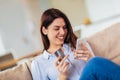 Woman hands holding a credit card and using smart phone for online shopping Royalty Free Stock Photo