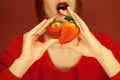 Beautiful woman hands holding some strawberries in her hands