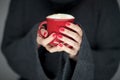 Beautiful woman hands with perfect nail polish holding coffee mug cup in her hand Royalty Free Stock Photo
