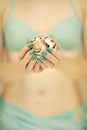 Beautiful woman hands with perfect nail polish holding little sea shell, summerly beach mood