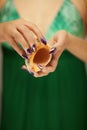 Beautiful woman hands with perfect nail polish holding little sea shell, summerly beach mood