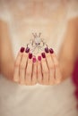 Beautiful woman hands with perfect pink nail polish holding little octopus brooch