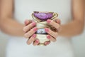 Beautiful woman hands with perfect pink nail polish holding little vintage tea cups