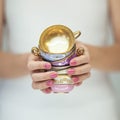 Beautiful woman hands with perfect pink nail polish holding little vintage tea cups Royalty Free Stock Photo