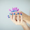 Beautiful woman hands with perfect violet pink and turquoise nail polish Royalty Free Stock Photo