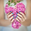 Beautiful woman hands with perfect violet pink and turquoise nail polish holding pink roses Royalty Free Stock Photo