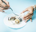 Beautiful woman hands with pink manicure holding plate with pearls and sea shells, luxury jewelry concept Royalty Free Stock Photo