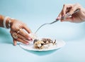 Beautiful woman hands with pink manicure holding plate with pearls and sea shells, luxury jewelry concept Royalty Free Stock Photo