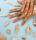 beautiful woman hands with pink manicure holding plate with pearls and sea shells, luxury jewelry concept Royalty Free Stock Photo
