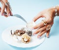 Beautiful woman hands with pink manicure holding plate with pearls and sea shells, luxury jewelry concept Royalty Free Stock Photo