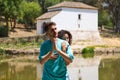 beautiful woman and handsome man latinos dancing bachata are dancing by the river in the forest. The couple do different postures Royalty Free Stock Photo