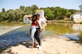 Beautiful woman and handsome man latinos dancing bachata are dancing by the river in the forest. The couple do different postures Royalty Free Stock Photo