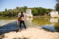 beautiful woman and handsome man latinos dancing bachata are dancing by the river in the forest. The couple do different postures Royalty Free Stock Photo