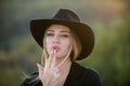 Beautiful woman in hat. Cowgirl in cowboy hat with finger gun. Portrait of young woman outdoor. Romantic girl with Royalty Free Stock Photo