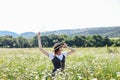 beautiful woman in a hat in a field of chamomile flowers Royalty Free Stock Photo