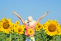 Beautiful woman with hat on her head in sunflowers field Royalty Free Stock Photo