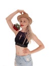 Beautiful woman with hat and rose in mouth Royalty Free Stock Photo