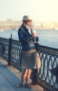 Beautiful woman in hat and scarf enjoy sunlight in the city Royalty Free Stock Photo