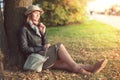 Beautiful woman in hat and scarf enjoy sunlight in the city Royalty Free Stock Photo