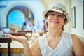 Beautiful woman in hat sitting in coffee