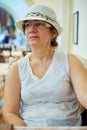 Beautiful woman in hat sitting in coffee