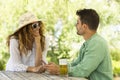 A beautiful woman in a hat and sunglasses seduces a beautiful and lonely man Royalty Free Stock Photo