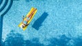 Beautiful woman in hat in swimming pool aerial drone view from above, young girl in bikini relaxes and swims Royalty Free Stock Photo