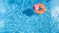 Beautiful woman in hat in swimming pool aerial top view from above, young girl in bikini relaxes and swims on inflatable ring Royalty Free Stock Photo