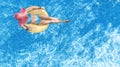 Beautiful woman in hat in swimming pool aerial view from above, young girl in bikini relaxes and swims on inflatable ring donut Royalty Free Stock Photo