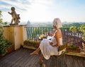 Woman having breakfast on balcony in city Royalty Free Stock Photo