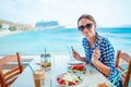 Woman drinking hot coffee on luxury hotel terrace with sea view at resort restaurant. Royalty Free Stock Photo