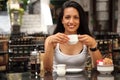 Beautiful woman having coffee in courtyard cafe