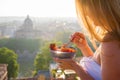 Woman having delicious healthy breakfast on terrace in city Royalty Free Stock Photo