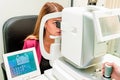 Beautiful woman having an eye lens exam Royalty Free Stock Photo