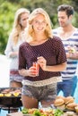 Beautiful woman having juice at outdoors barbecue party Royalty Free Stock Photo