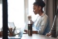 Beautiful woman having a morning coffee at her desk in the office. Young woman drinking coffee at the workplace. Royalty Free Stock Photo