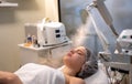 Beautiful woman having treatment of face with ozone facial steamer in beauty clinic. Royalty Free Stock Photo