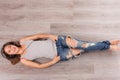 Beautiful woman with headphones lying on the floor Royalty Free Stock Photo