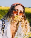 Beautiful woman with a headscarf walking through a field of flowers Royalty Free Stock Photo