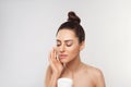 Beautiful Woman with healthy smooth facial clean skin holding bottle cosmetic cream. Model with Beauty face. Face Skin care Moistu Royalty Free Stock Photo