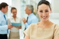 Beautiful woman with her business team at the back. Beautiful young woman smiling with her business team at the Royalty Free Stock Photo