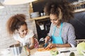 Beautiful woman and her daughter cooking in the kitchen Royalty Free Stock Photo