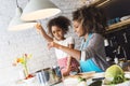 Beautiful woman and her daughter cooking in the kitchen Royalty Free Stock Photo