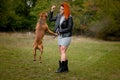 Beautiful woman and her dog in fall park Royalty Free Stock Photo