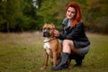 Beautiful woman and her dog in fall park Royalty Free Stock Photo