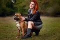 Beautiful woman and her dog in fall park Royalty Free Stock Photo