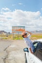 Beautiful woman on her trip by the car. Welcome to Utah road sign. Large welcome sign greets travels in Monument Valley Royalty Free Stock Photo